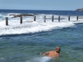 Swimming in the waves at Mahon Pool at Maroubra